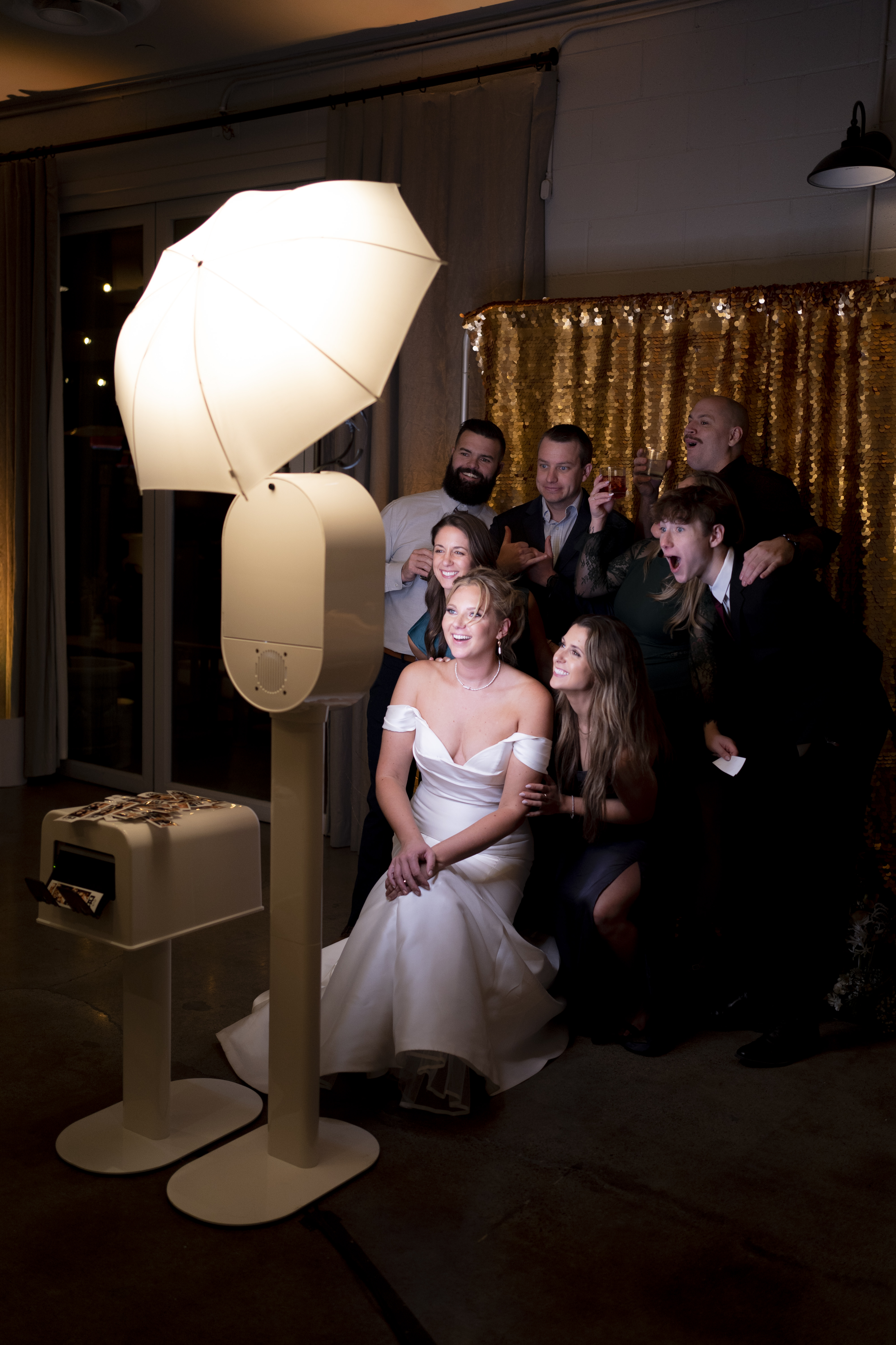 Bride and wedding guests enjoying a photo booth